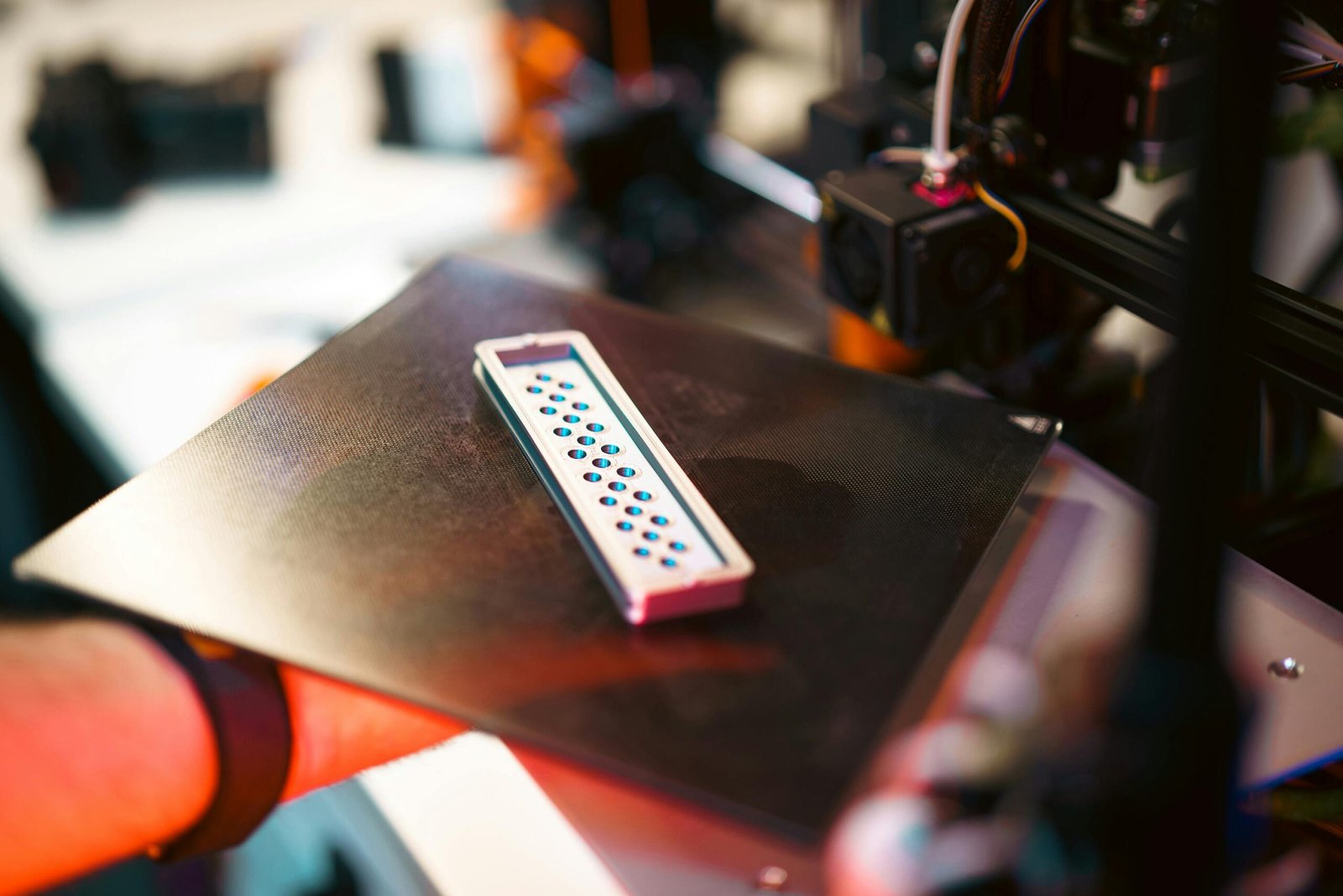 Engineers inspecting custom manufactured products on an assembly line.