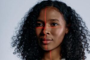 A futuristic portrait of a woman with laser scanning lines on her face, representing advanced technology